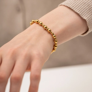 Elegant gold spherical bead bracelet for women made of durable stainless steel