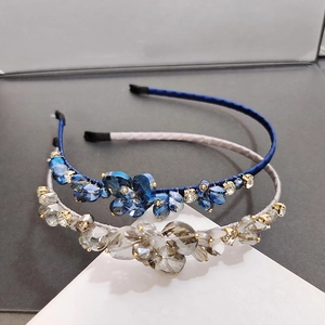 Detail of blue and grey handmade crystal beads on a satin-wrapped metal headband