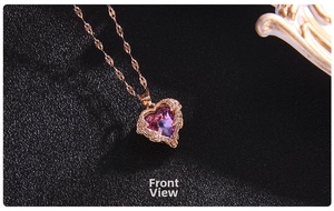 Detail of heart pendant with purple crystal and small diamonds in rose gold finish
