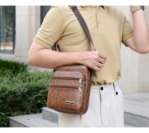 Brown PU leather messenger bag for men featuring multiple zipper compartments and adjustable strap