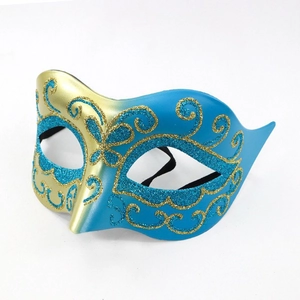 Detailed close-up of blue and gold masquerade mask with glittering scrollwork patterns