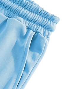 Detail view of elastic drawstring waistband and side pockets on men's linen pants