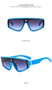 Detail of blue oversized shield sunglasses with gold star accent and gradient lenses