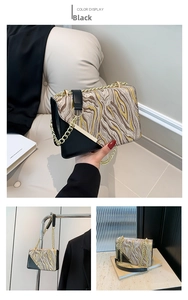 Detail of crossbody bag featuring abstract fluid marble pattern and gold chain strap