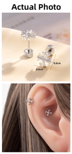Macro shot of a 0.6cm silver cross stud earring with screw back and ear bone display