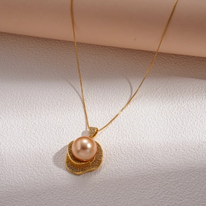 Close-up of champagne pearl necklace with rhinestone-encrusted gold flower pendant