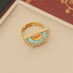 Detail view of gold fan-shaped necklace with light blue and coral enamel inlay in a jewelry box