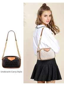 Detail of trendy tote bags in black and cream with gold chain and underarm carry style