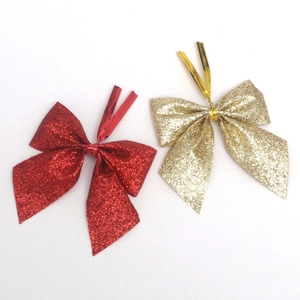 Glittering red and gold Christmas bows with metallic wire ties for festive tree decoration