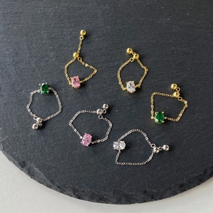 Macro detail of adjustable S925 silver chain rings with oval colorful zircon stones
