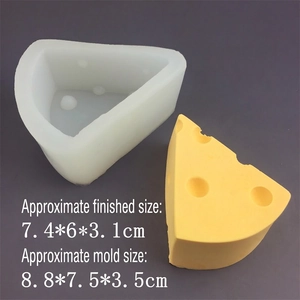 Cheese shape silicone mold with yellow finished dessert on a dark background