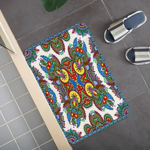 Detail of bohemian mandala flannel mat on gray tile floor with vibrant floral pattern