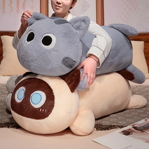 Close-up of soft plush cat pillows in grey and cream colors for home decoration