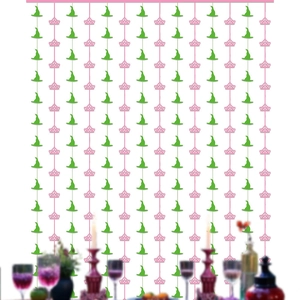 Detail of Halloween party backdrop with green witch hats and pink crowns on tinsel curtains