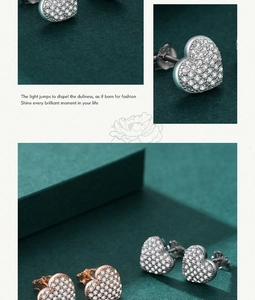 Detailed macro view of heart-shaped pave stud earrings in silver and rose gold finish