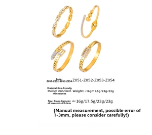 Detailed set of gold plated titanium steel bangles with chain link and pave diamond patterns