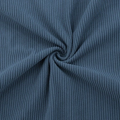 Macro shot of dark blue corduroy fabric showing vertical ribbed texture and soft drape