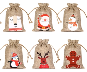 Detail showing 6 Christmas linen drawstring gift bags with reindeer and Santa patterns