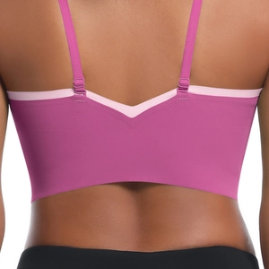 Detail of cross-strap back and adjustable sliders on two-tone pink sports bra