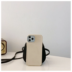Close-up of minimalist cream white silicone phone case next to a vintage speaker