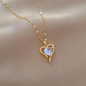 Luxurious gold heart pendant necklace with large clear gemstone and sparkling crystals