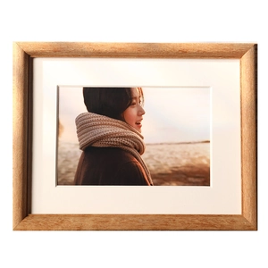 Classic rectangular natural wood photo frame with matted lining and portrait display