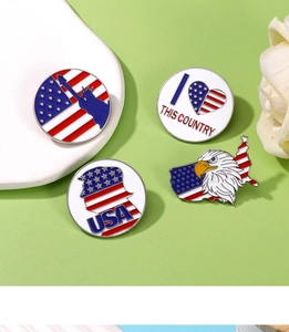 Detailed view of four USA theme enamel pins featuring Statue of Liberty and eagle designs