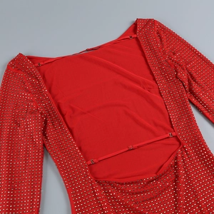 Detail of red backless dress with gold stud embellishments and adjustable thin straps