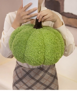 Detailed view of the soft green pumpkin plush pillow with textured teddy velvet fabric