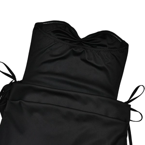 Detail of the black strapless dress featuring smooth fabric and side lace-up drawstring design