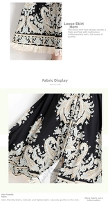 Détail d'une robe imprimée paisley avec tissu noir et décoration de pompons blancs sur l'ourlet