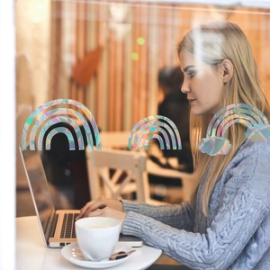 Rainbow prism window film stickers showing holographic arc effect on a cafe glass