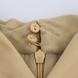 Elegant khaki halter dress featuring high-quality back zipper and button closure detail