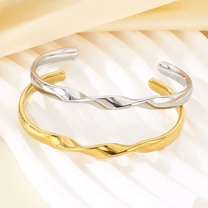 Minimalist twisted wave bangles in 18K gold and silver plated stainless steel