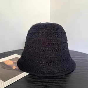 Detailed close-up of hollow crochet texture on a black breathable knitted bucket hat