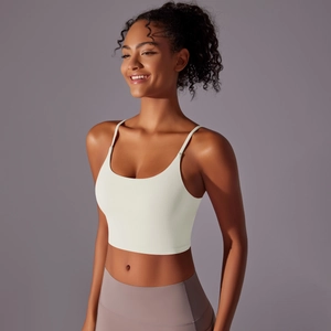Close-up of white thin strap yoga top with backless design and high-elastic fabric detail