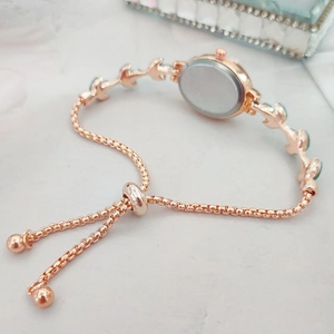 Detail of rose gold bolo clasp and adjustable box chain with green crystal leaf links