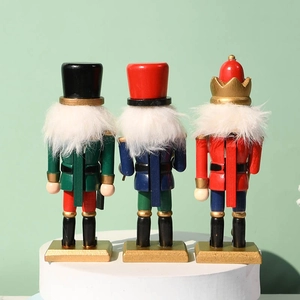 Back view of three 15cm wooden nutcracker soldier ornaments on a gold base