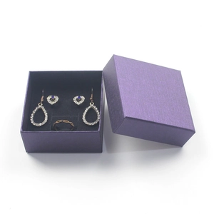 Purple jewelry gift box featuring heart studs, teardrop earrings and a gold twisted ring