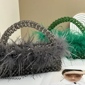 Detailed view of grey and green beaded evening bags with luxury ostrich feathers and beads