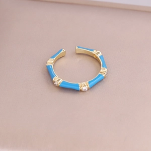 Detail of bamboo-shaped gold ring with blue enamel and sparkling micro-inlaid stones