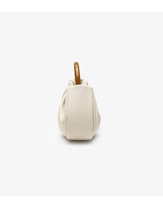 Side view of beige pleated cloud handbag with unique curved amber resin handle