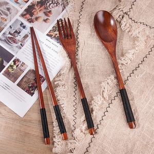 Japanese style nanmu wood cutlery set with black cord wrap on beige linen fabric
