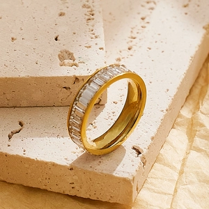 Detailed macro view of gold-plated eternity ring with rectangular baguette cut zircons