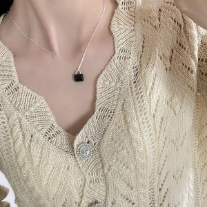 925 silver necklace with black zircon square pendant on model in beige knitwear