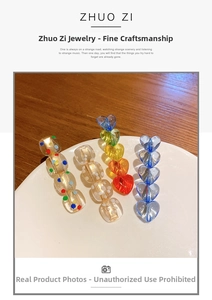 Macro detail of acrylic hair clips with colorful polka dots and heart-shaped beads