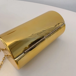 Top view of gold cylindrical acrylic evening bag featuring a metallic mirror finish and chain