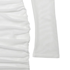 Detailed view of white mesh sleeve and ruched fabric texture on this slim fit dress