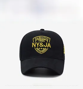 Detailed view of yellow embroidery on black cotton twill fabric of the baseball cap