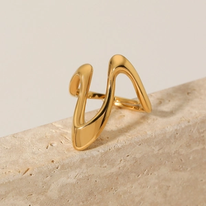 Irregular gold wave stainless steel open ring displayed on a natural beige stone